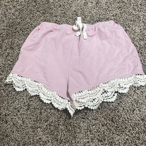 These shorts are a very mellow pink with white stringing on the bottom! Kids 8